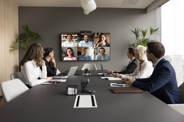 Office staff meeting with diverse freelance team on online video